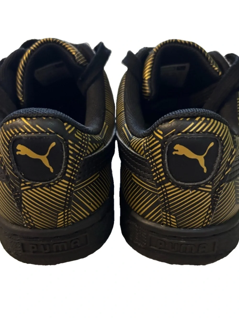 Puma low-top sneaker in black and metallic gold geometric print